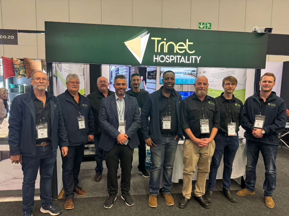 The Trinet team standing in front of the stand